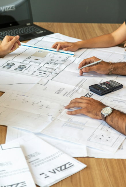 people-reviewing-architectural-blueprints-on-desk.jpg people reviewing architectural blueprints on desk